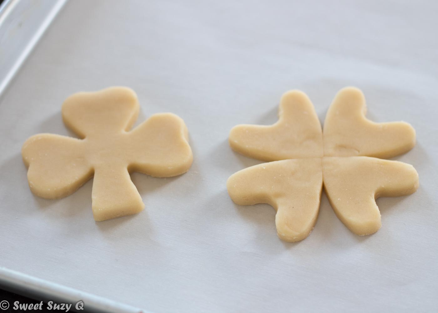 4 leaf clover cookie next to the shamrock cookie